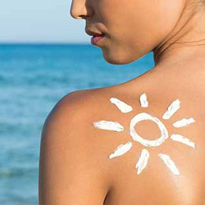 Woman with sunscreen solar cream